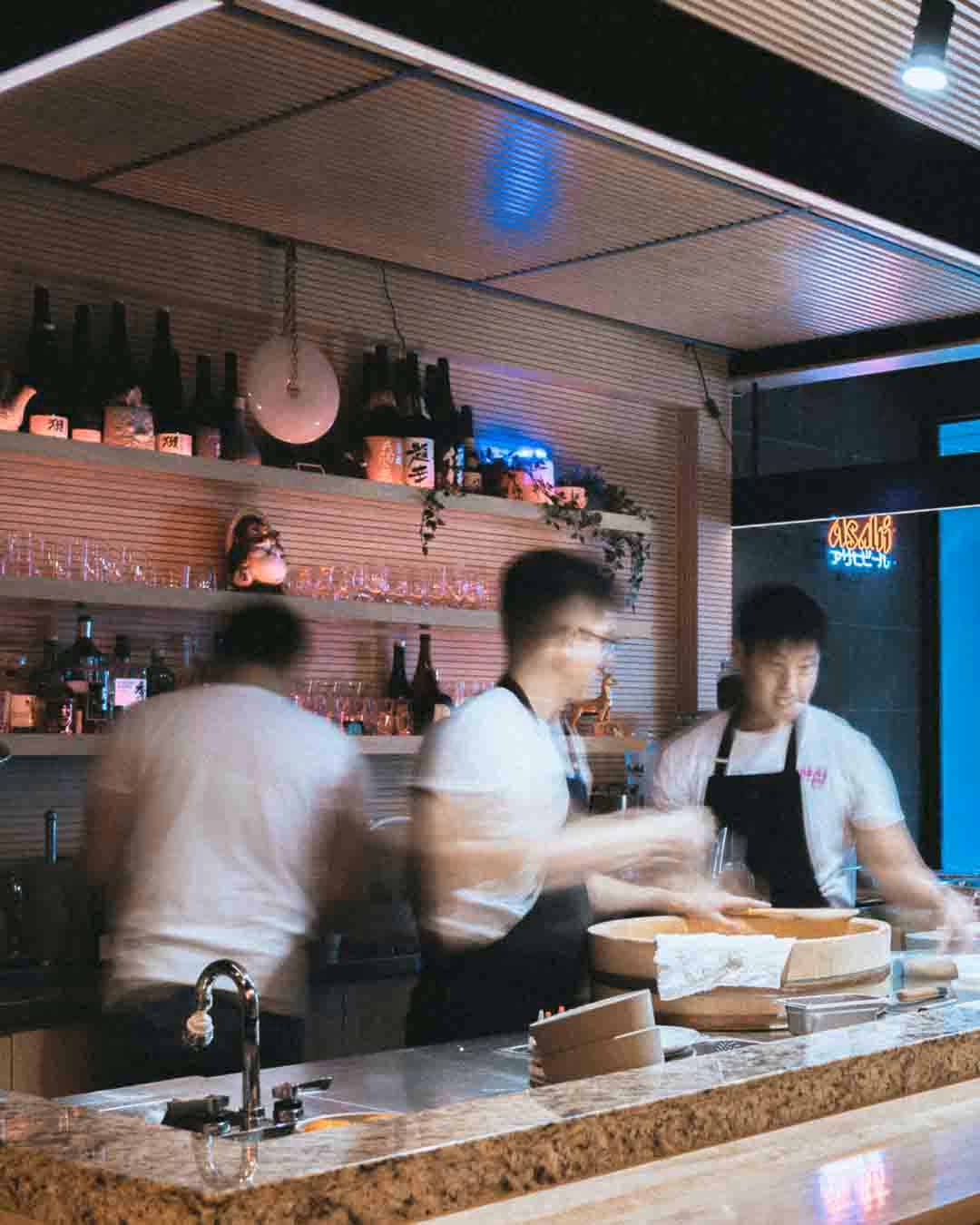 Sushi chefs behind the counter at Omai in Toronto, photographed by Jasmine Tam